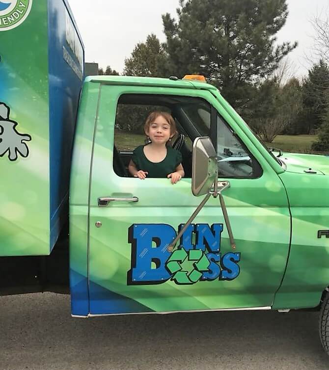 Child in passenger seat of Bin Boss truck