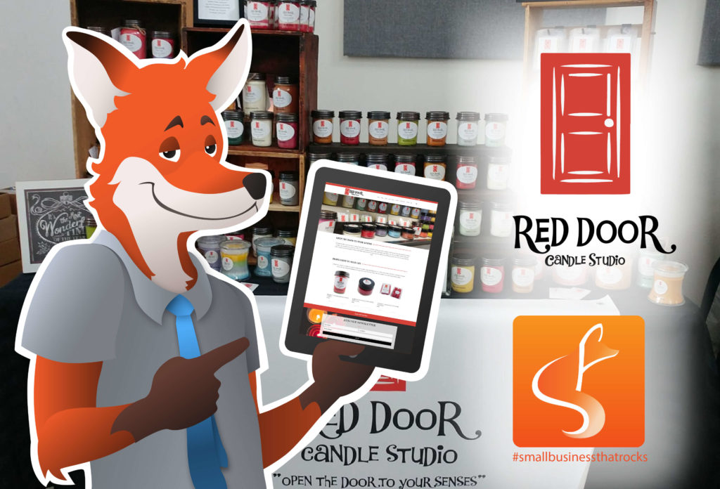 SlyFox Mascot pointing to screen displaying Red Door Candle Studio web page - SlyFox Web Design and Marketing