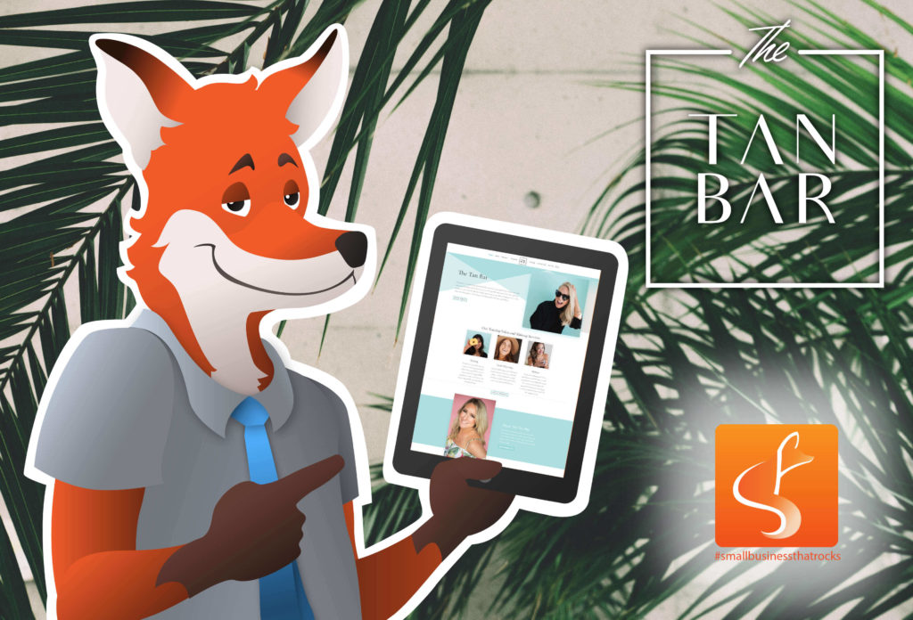 Sly Fox's Mascot Holding a Phone with The Tan Bar's website Front Page on it With both Sly Fox and The Tan Bar's Logos - SlyFox Web Design and Marketing