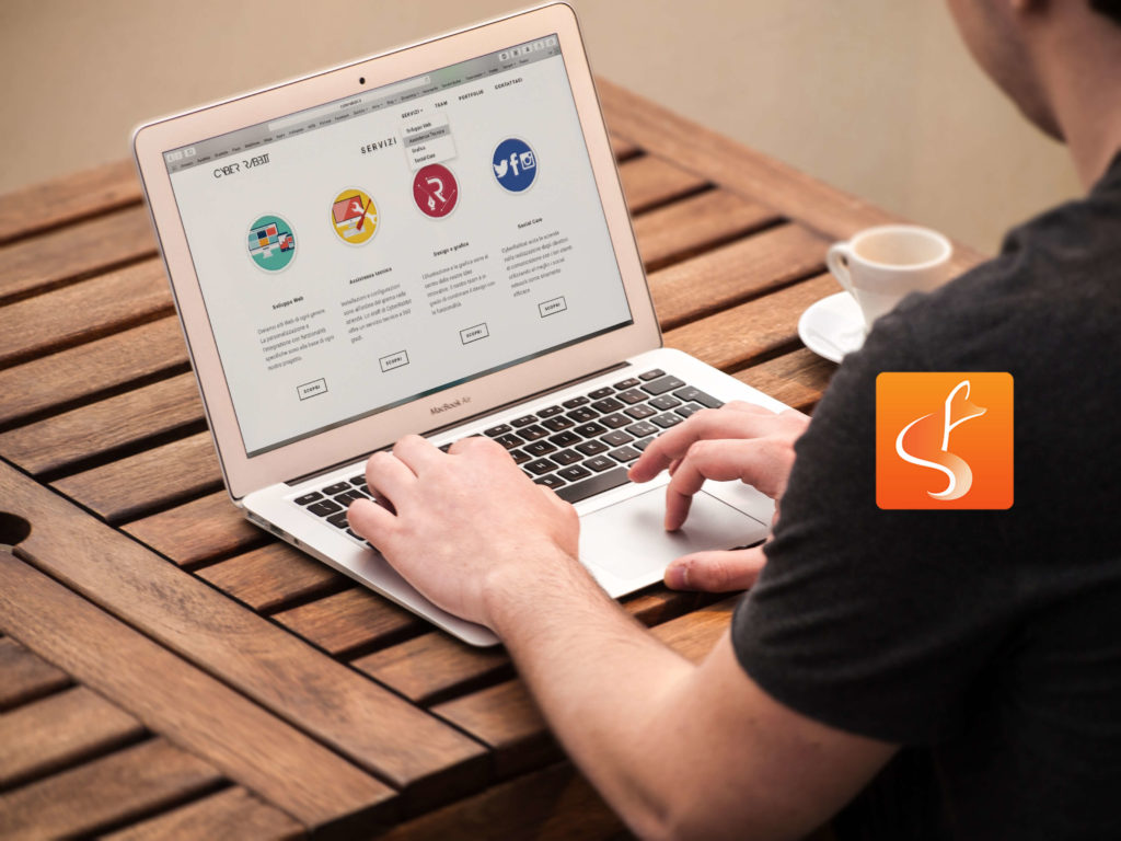 slyfox logo with man on laptop in background - SlyFox Web Design and Marketing