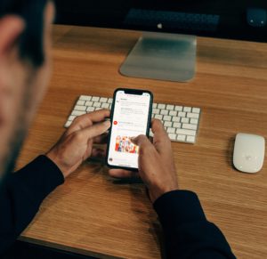 man using phone to check email